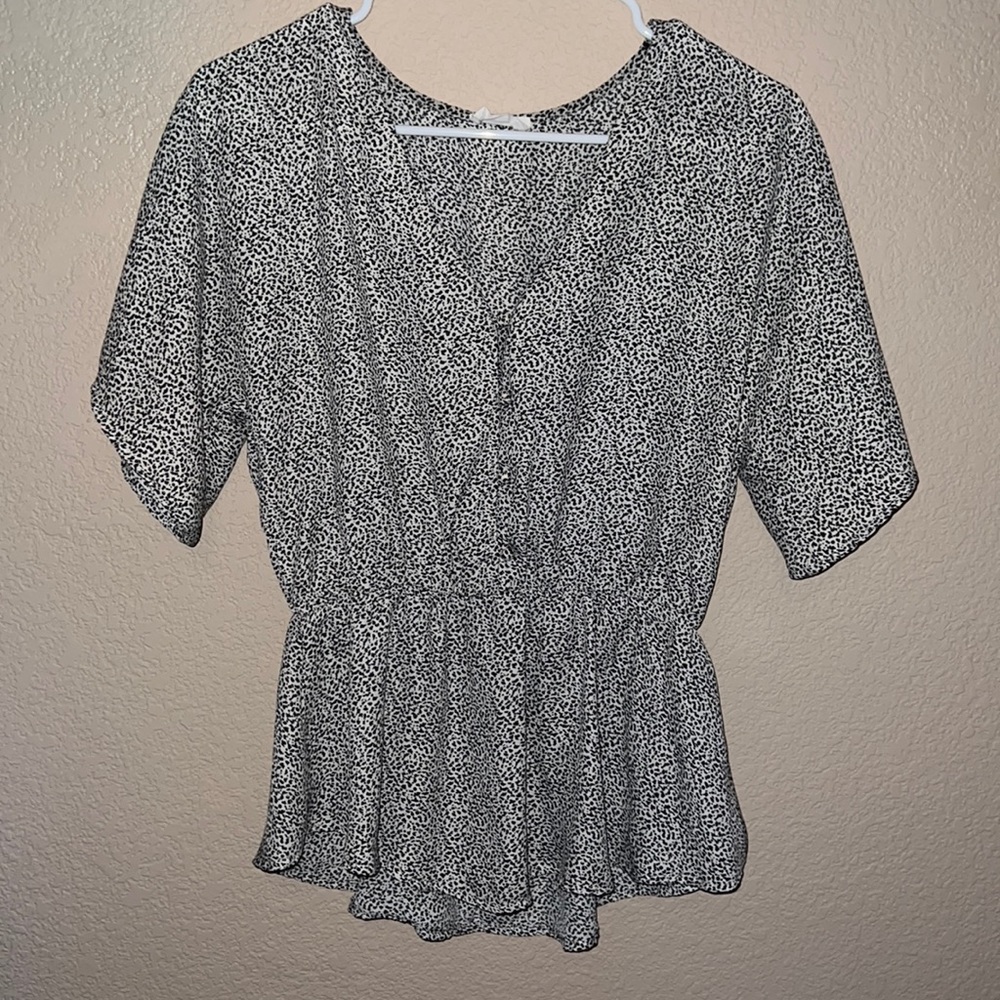 Black and white spotted, peplum top.